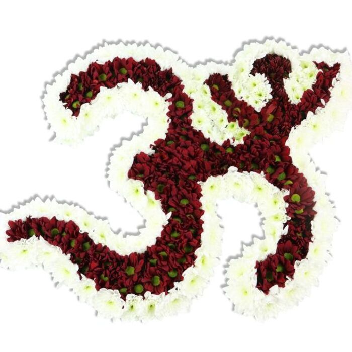 An ornate floral Om (Aum) symbol presented against a stark white backdrop, each element revealing careful floral workmanship from a neighbourhood florist. The principal form - the familiar '3'-shaped curve, the descending S-like stroke and the crescent with dot above - is densely composed of small, velvety deep red to maroon chrysanthemum-style blooms. Many of these tiny pompon flowers show a contrasting lime-green centre that adds gentle texture and life to the rich red field. A pronounced, continuous border of pure white spray chrysanthemums encircles the red interior, sculpting the negative spaces and lending the symbol a luminous edge that reads both devotional and modern. The blooms are packed so closely the surface appears plush and tactile, while a soft drop shadow beneath gives the work a three-dimensional, almost reliquary quality.

The arrangement carries an understated, earthy scent and the imagined cool touch of countless silky petals - qualities that make it suitable for reverent ceremonies, memorial tributes, or spiritual gatherings. As a local piece, it reflects the kind of bespoke tribute crafted for Nine Elms and the surrounding Battersea and Vauxhall communities, and such work can be prepared by Florist Nine Elms for events near the Thames or private altars in the area. It marries floral artistry to sacred symbolism with quiet respect and precise craftsmanship.