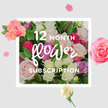 A romantic, full-bodied bouquet of roses dominates the image, offering a quiet yet joyful promise of flowers arriving month after month to brighten life in Nine Elms. The arrangement is lush and rounded, dense with rose heads in every gentle hue: powdery blush, creamy vanilla, soft lilac, deeper raspberry, and flashes of bold fuchsia, all woven through a backdrop of lively green leaves. Some roses are fully open, showing petals that curl outwards like silk ribbons, while others remain in bud, their compact shapes hinting at the beauty still to come. Soft, diffused light bathes the bouquet, making the petals appear almost luminous, and casting subtle shadows that emphasise the depth and fullness of the design. Surrounding the main cluster, scattered petals and a few individual blooms rest on a pale, uncluttered background, reminiscent of the way petals might fall onto a kitchen table in a flat near the new US Embassy or along the tree-lined streets linking Vauxhall and Nine Elms. These details give the image a sense of relaxed elegance, like a candid moment captured just after a delivery is unboxed. The composition hints at the comforting repetition of a 12-month subscription-each new bouquet slightly different, yet always carrying the same soothing fragrance of fresh roses and greenery. It feels well suited to any occasion: from gentle get-well wishes to year-long birthday surprises or simply adding warmth and colour to modern riverside living, one bouquet at a time.